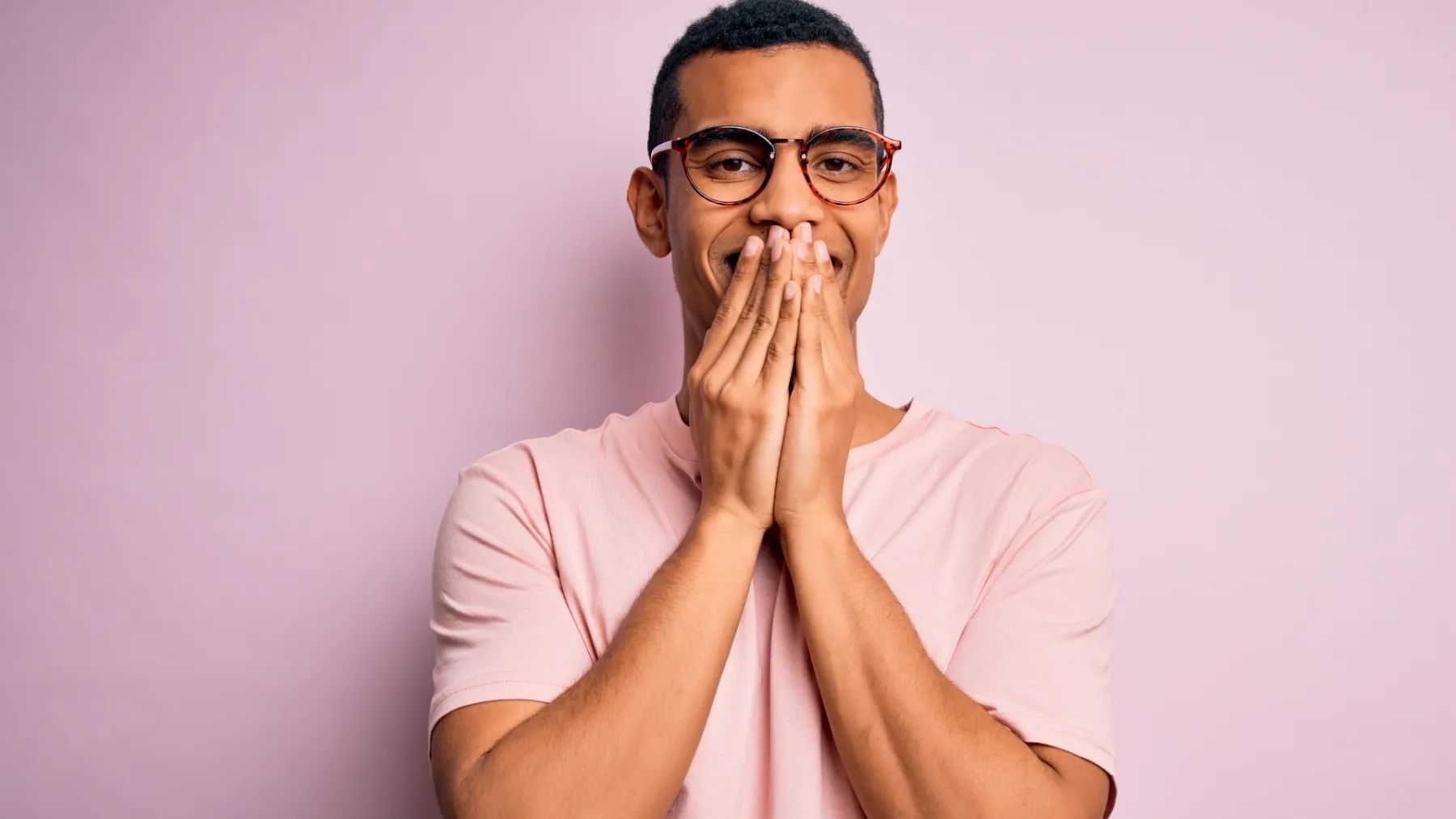 A man covers her mouth while smiling - Article Hero for 6 things that stain
