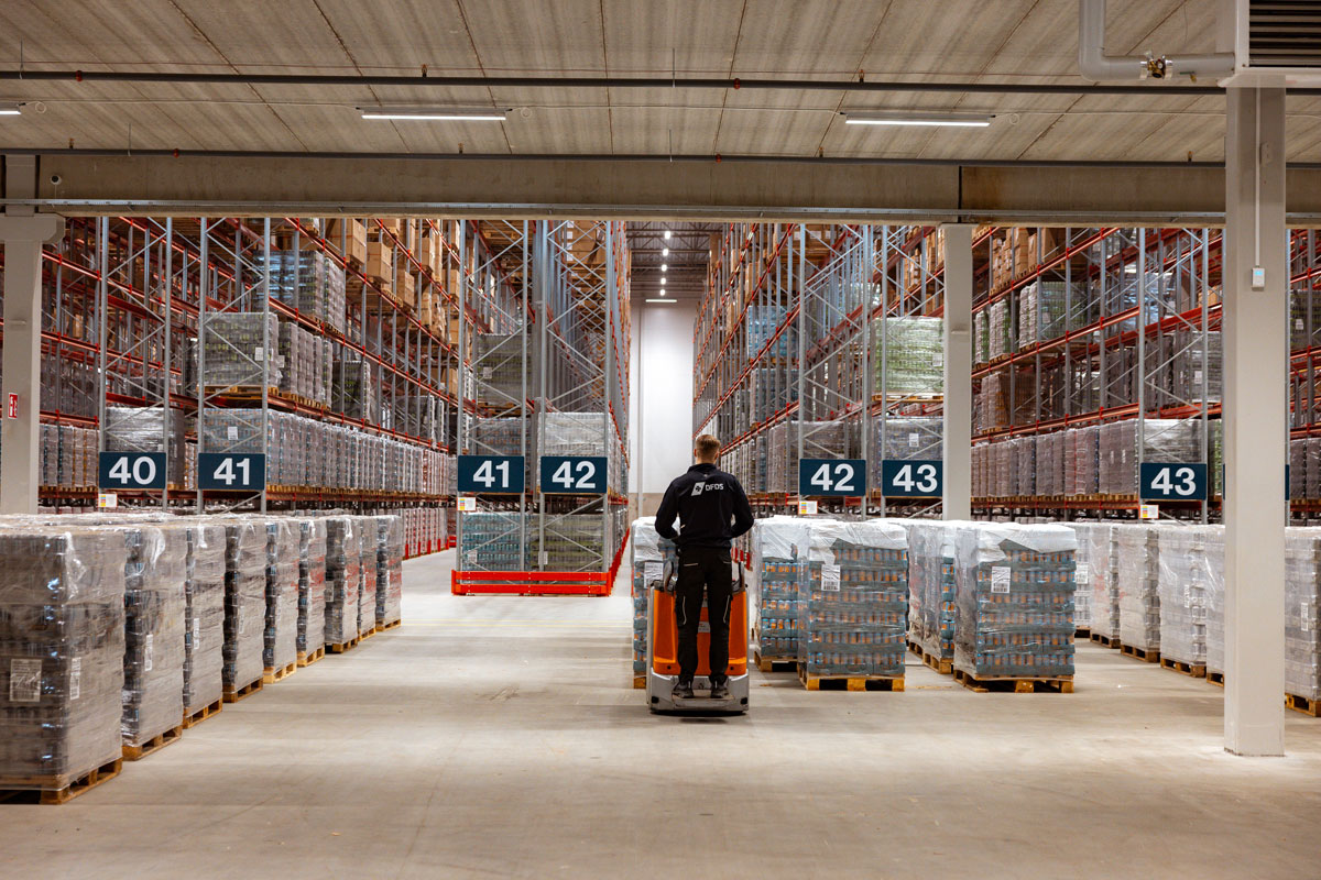 DFDS worker moving a pallet within a warehouse.