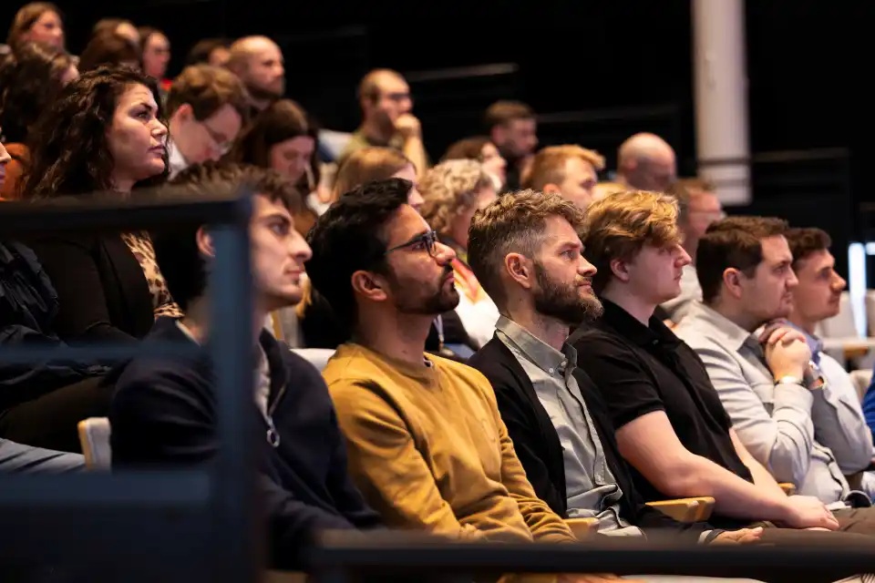 A group of people listening to the Geminor townhall presentation.