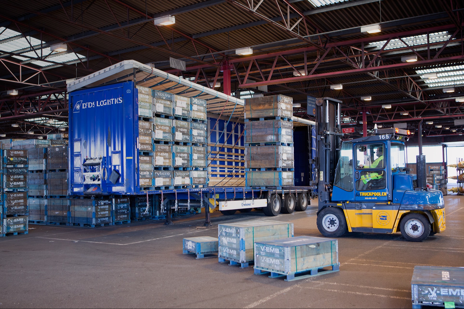 A forklift loading pallets into a container in a DFDS Logistics warehouse