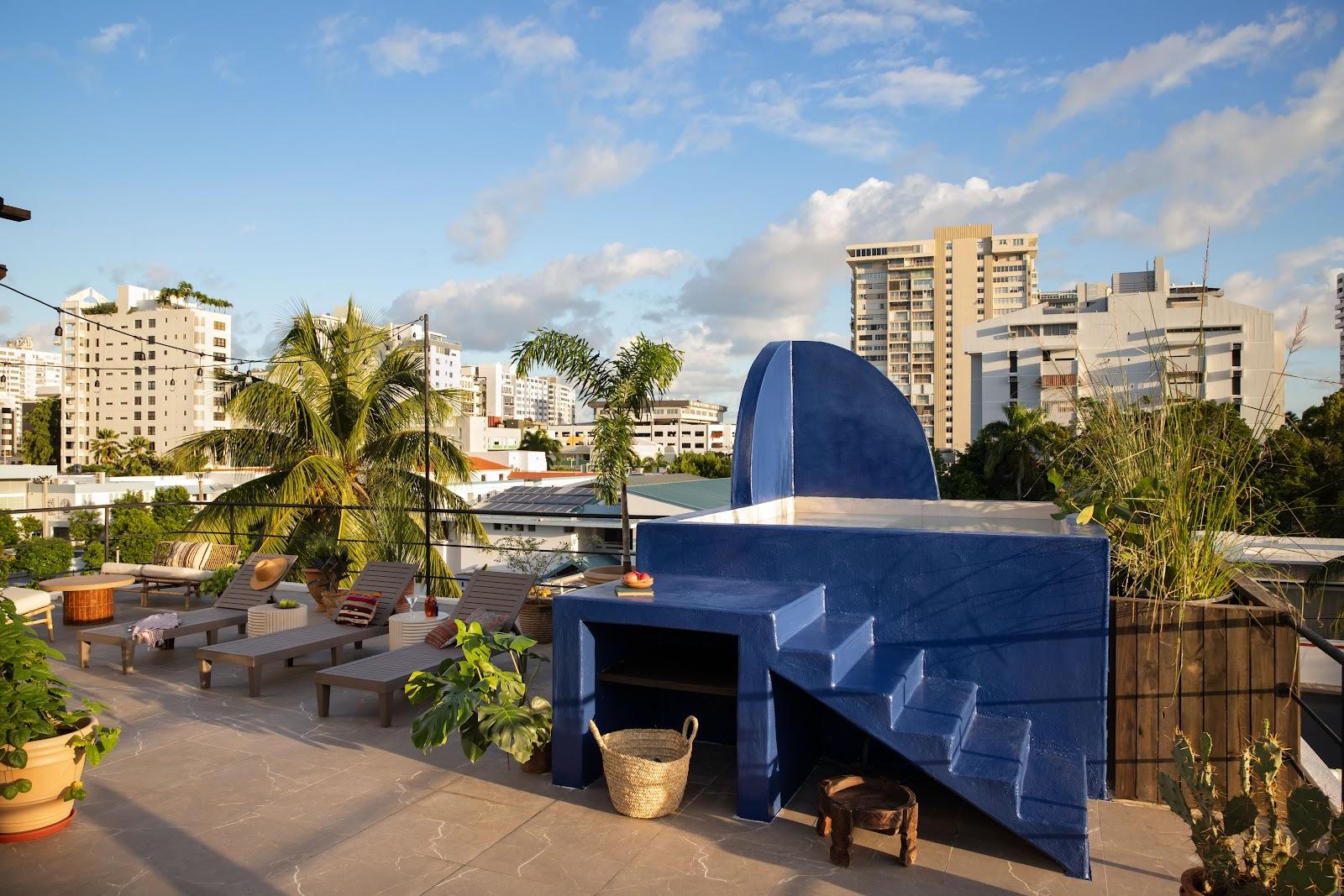 A rooftop terrace at Maru by DW in Condado, looking across the neighbourhood's low-rise roofs and towers.