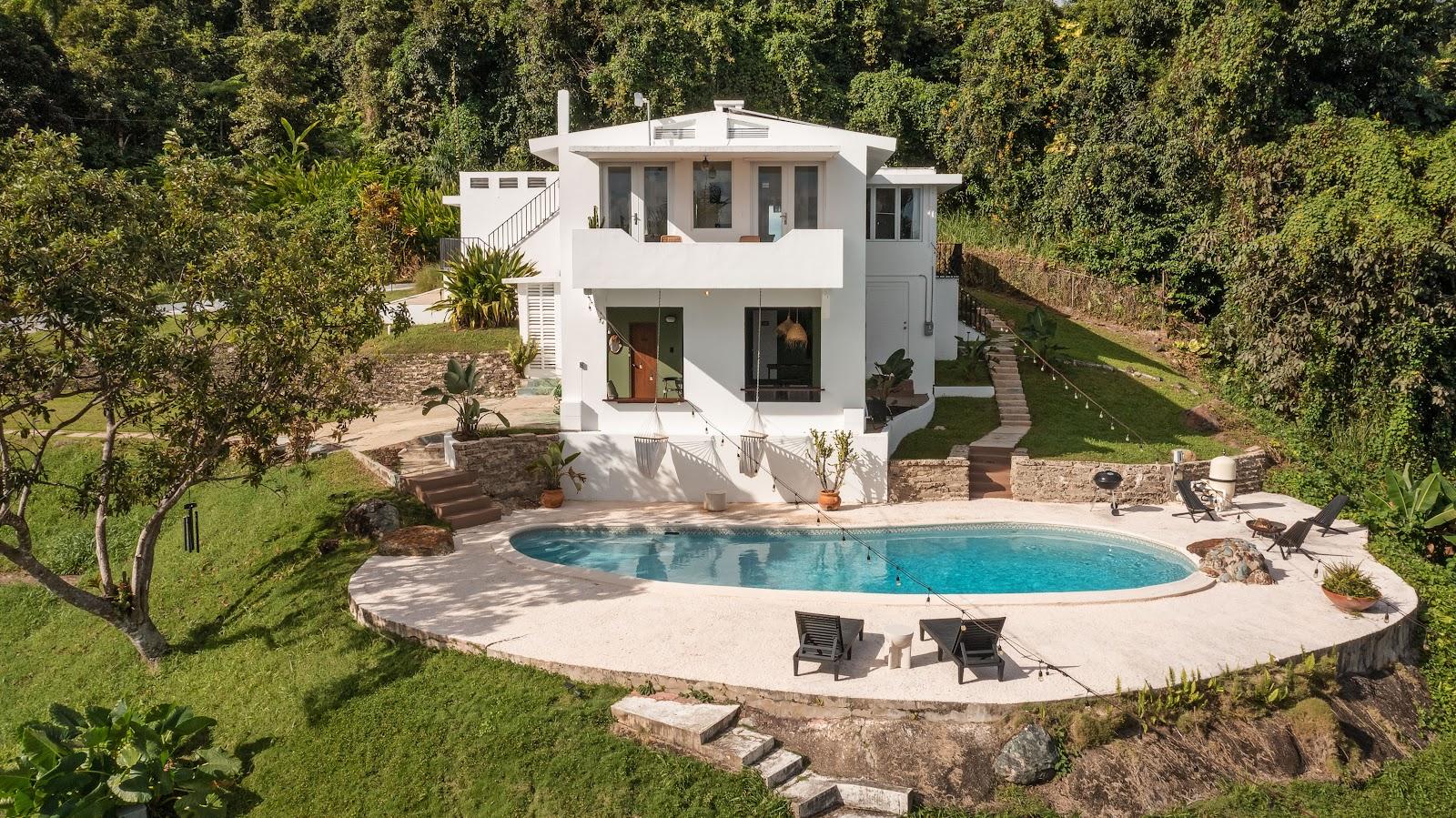 Wald Haus by DW from the air, the Dreamers Welcome house in Naguabo, with its pool and garden on the hillside.