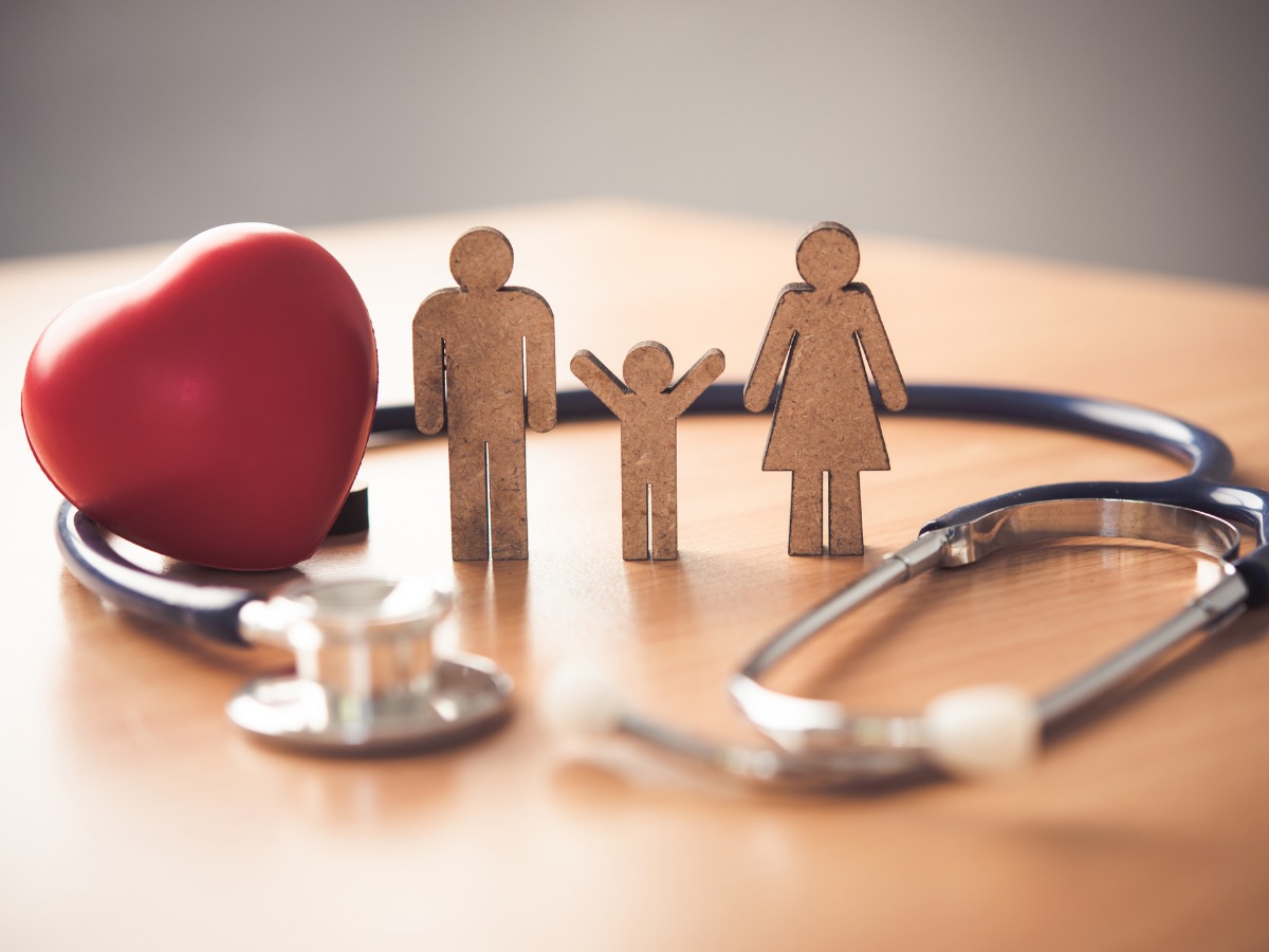 medical-insurance-concept-with-family-and-stethoscope-on-wooden-desk-picture-id1012323872