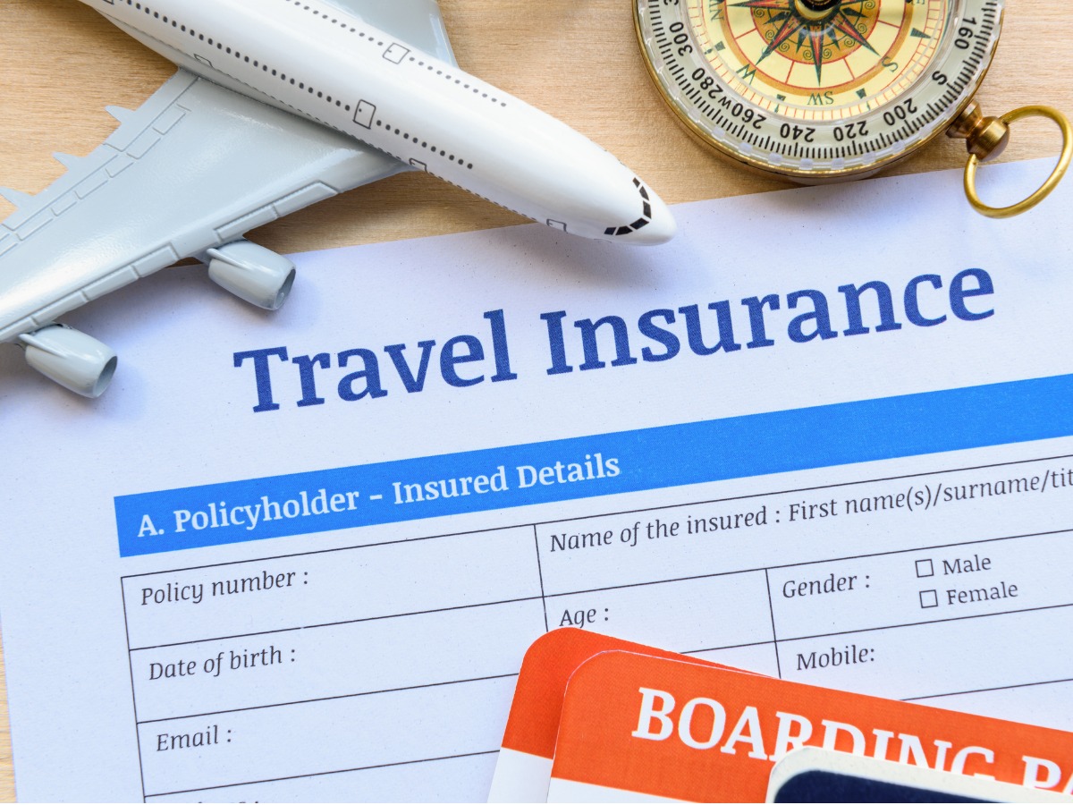 travel-insurance-form-put-on-a-wood-table-picture-id868511790