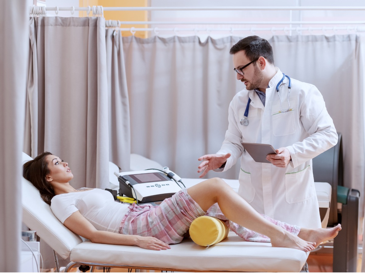 young-caucasian-doctor-in-white-uniform-holding-tablet-and-explaining-picture-id1151390604