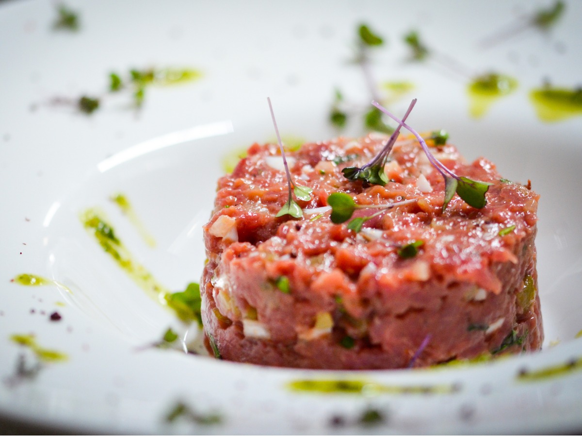 fresh-beef-tartar-dish-with-tasty-vegetables-picture-id1167058092