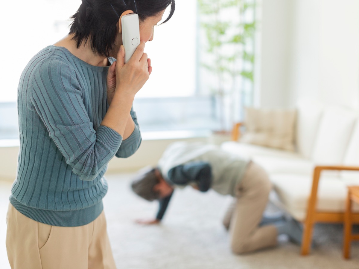 woman-asking-for-help-from-a-sick-and-fallen-senior-man-picture-id1163843486