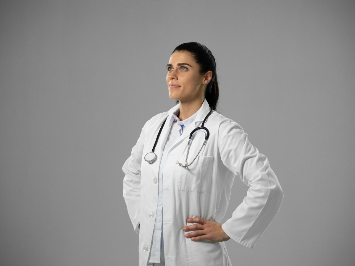 caucasian-female-doctor-on-grey-background-picture-id1210586041