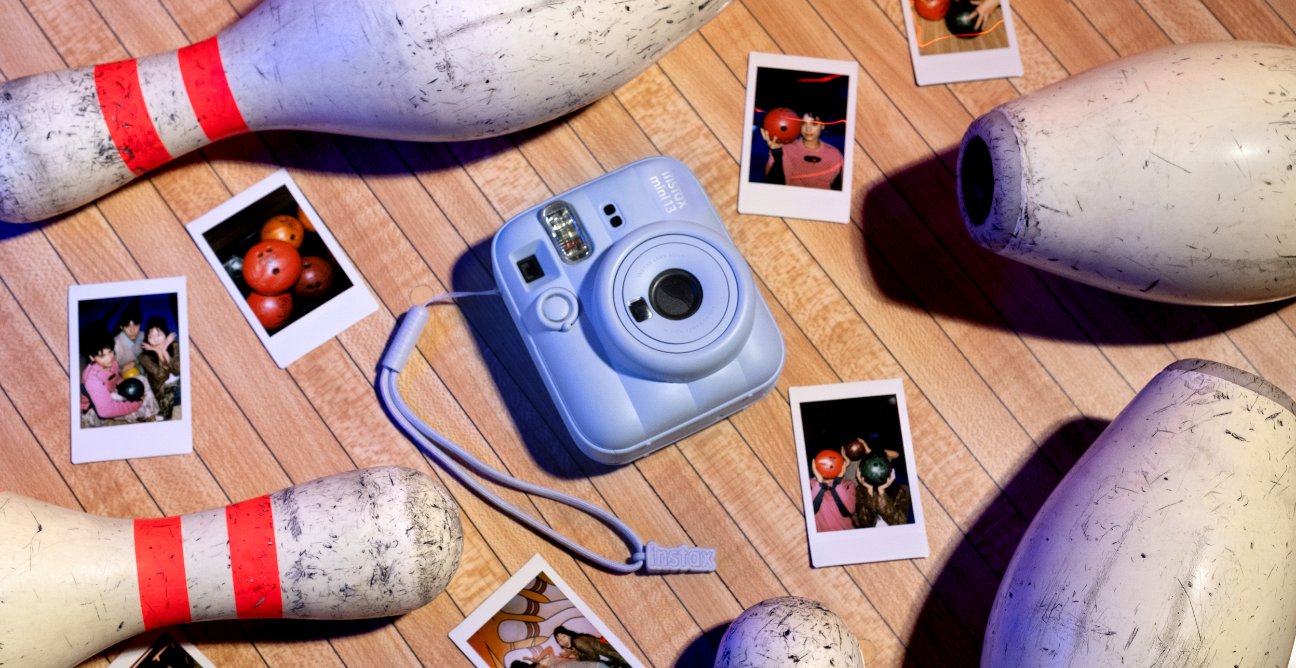 Instax camera surrounded by pictures