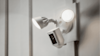 A security camera with sensor and spotlight.