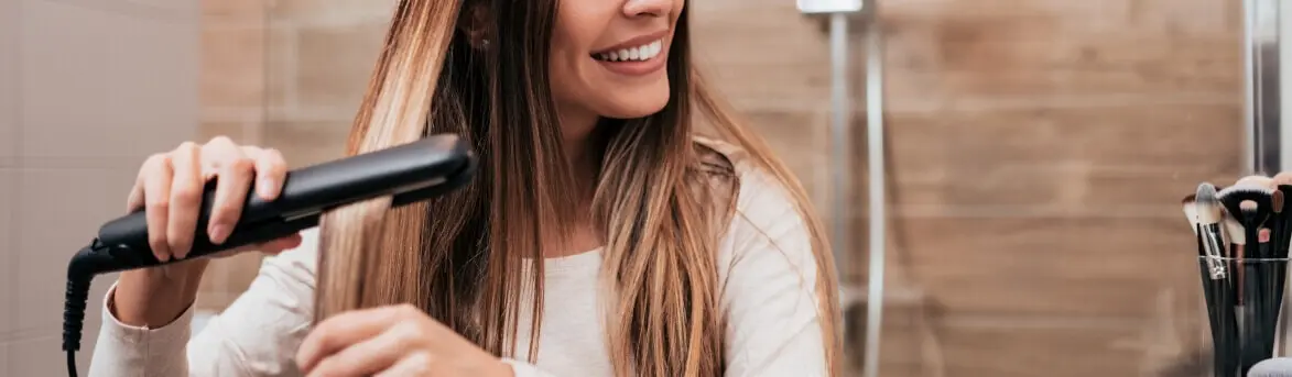 Woman Straightening Hair