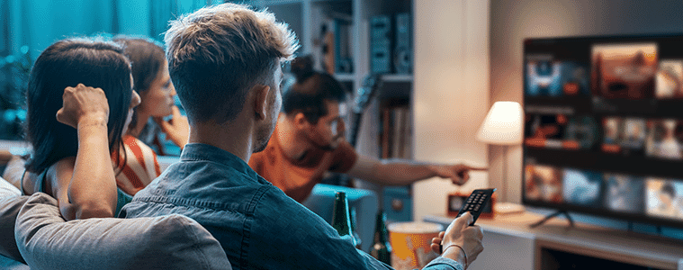 Friends watch movies together at home on the couch