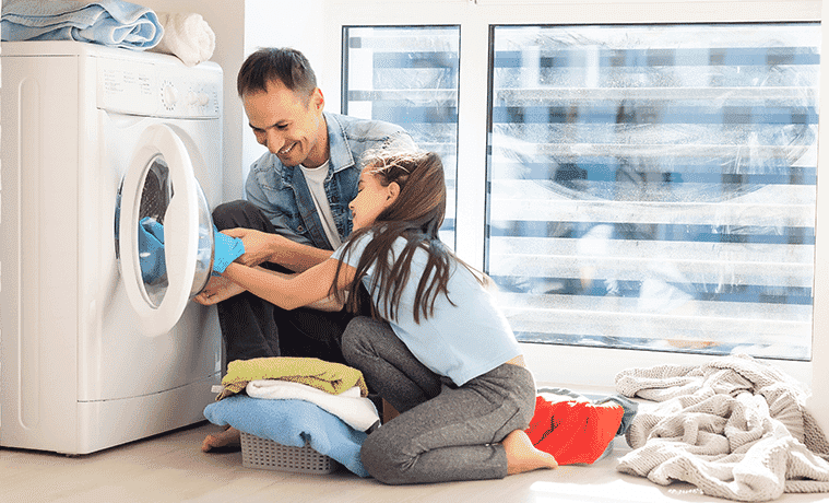 A father and daughter unload their dryer together