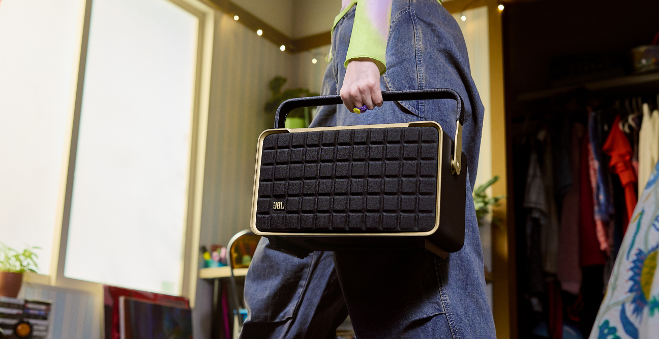 woman holds JBL true wireless earbudss
