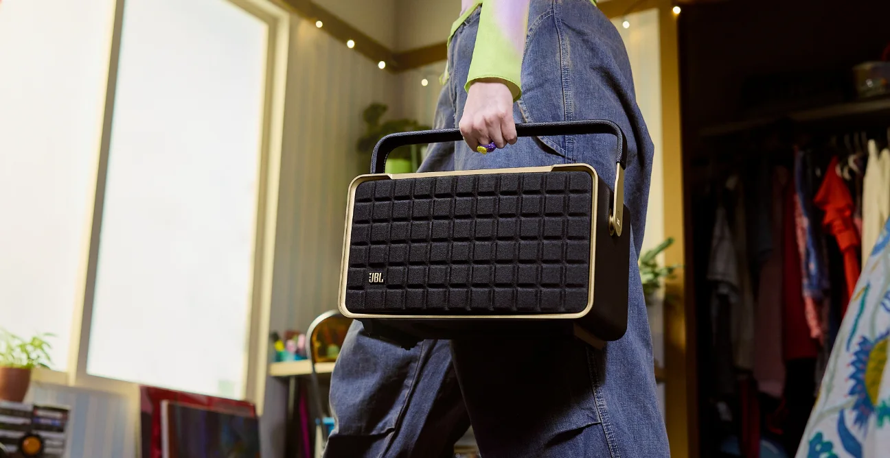 woman holds JBL true wireless earbudss