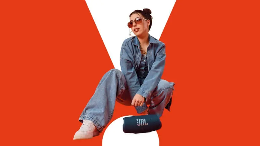 woman poses over JBL charge 5