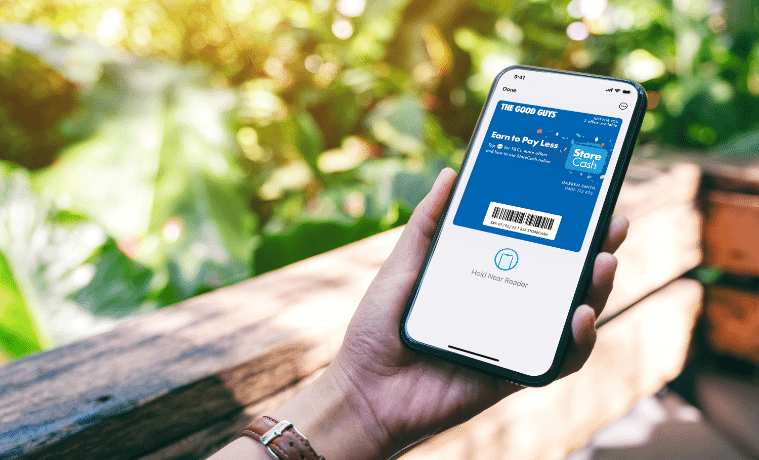 A woman opens The Good Guys StoreCash digital wallet on her smartphone to check on latest offers and deals