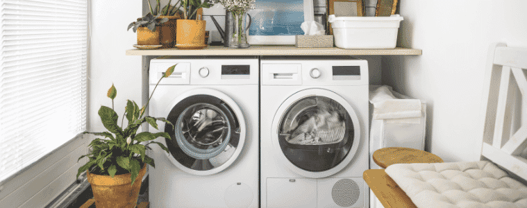 A washing machine and dryer sit sidebyside in a small laundry