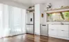 The Haier Dishwasher Satina matches a Haier fridge in a white kitchen