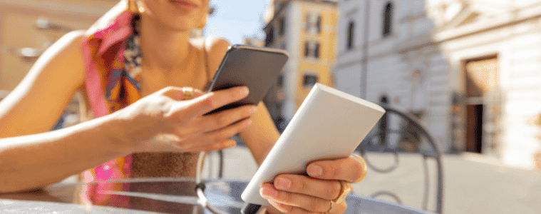 a woman charging her phone using a portable charger 