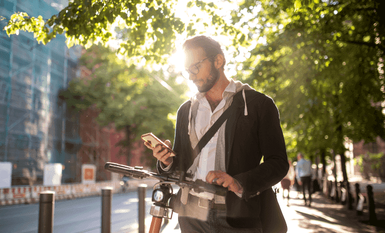 Man sets up his escooter rental on his mobile phone