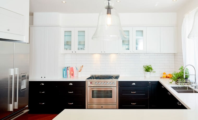 A modern black and white kitchen in a Ushape