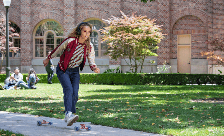 a girl skating on her skateboard whilst listening to music on her Bose Noise Cancelling Headphones