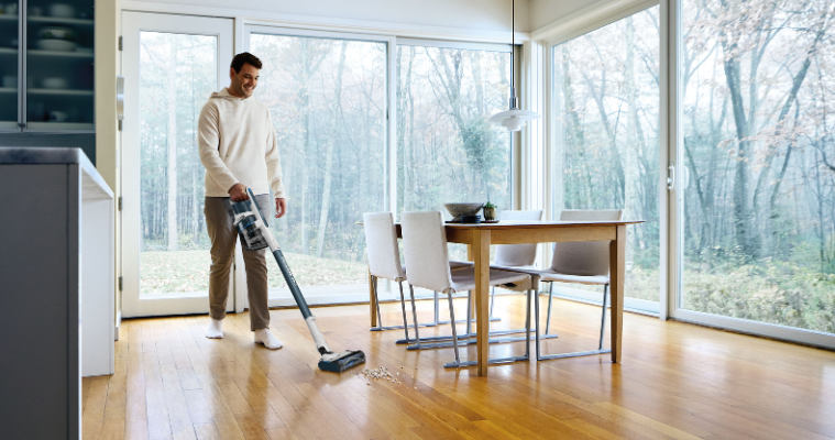 Man using Shark PowerPro to clean his home. 