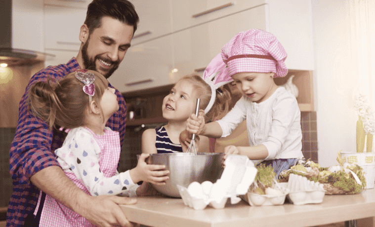 Father and his children cooking together in the kitchen