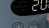 Close-up image of a woman turning the temperature dial on a Ninja Crispi Pro Air Fryer