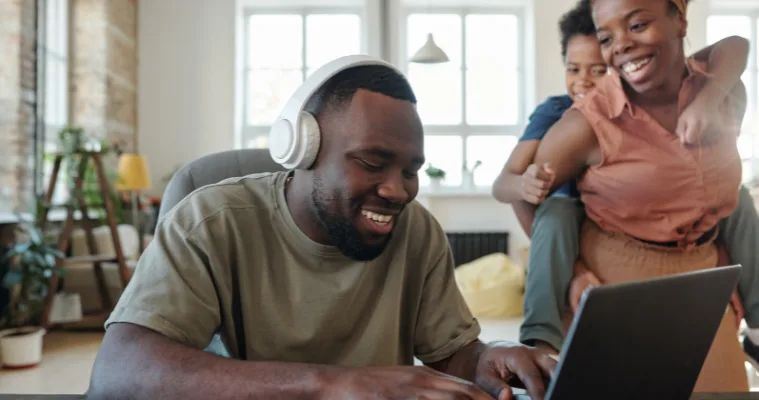 Woman relaxing in a park whilst reading and using her new Noise Cancelling Headphones