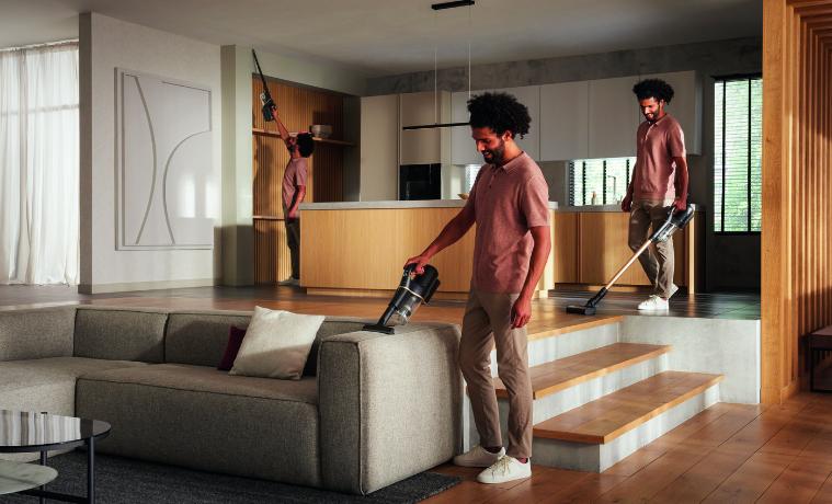 Man using Miele Duoflex HX1 Total Care Cordless Vacuum in living room