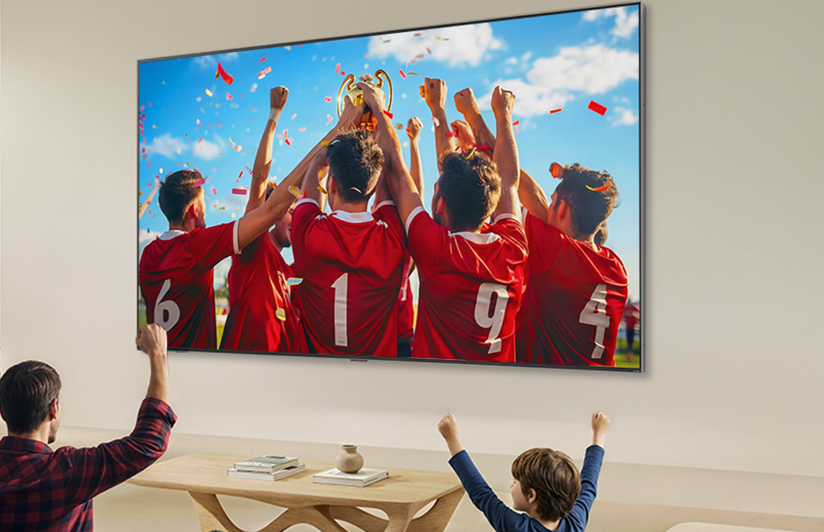 Father and son watching sport vividly on a big LG screen. 