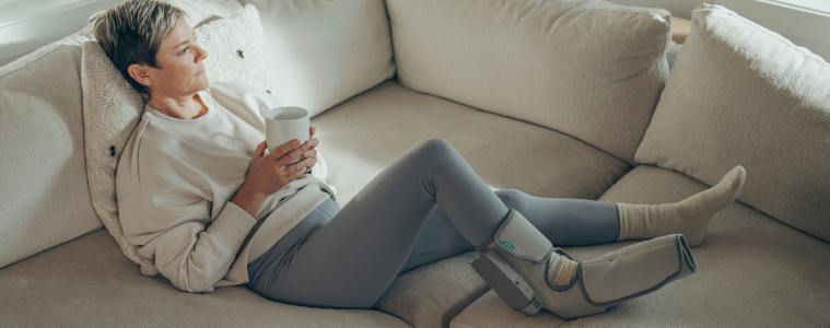 Woman wears Homedics Modulair Foot Compression Wrap