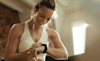 Woman in activewear checks her heart rate on her fitness tracker on her wrist
