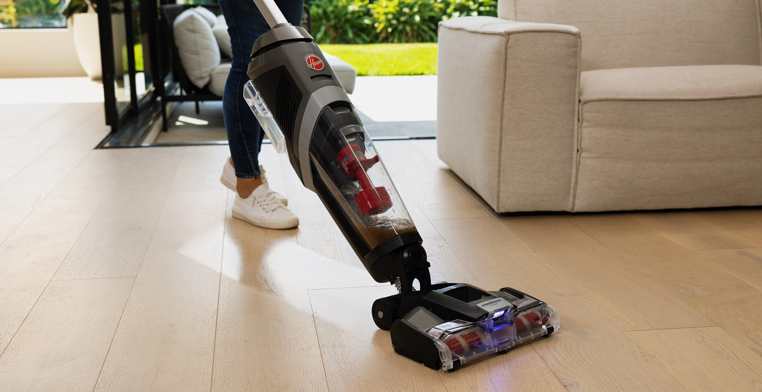person vacuums living room with Hoover ONEPWR FloorMate Advanced Cordless Hard Floor Cleaner