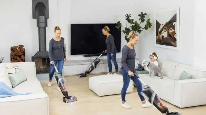 person vacuums living room with Hoover ONEPWR FloorMate Advanced Cordless Hard Floor Cleaner