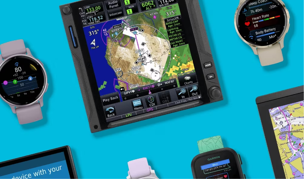 Flat lay image of Garmin watches and GPS on a blue background