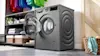 Graphite Bosch Washing Machine with door open in laundry.