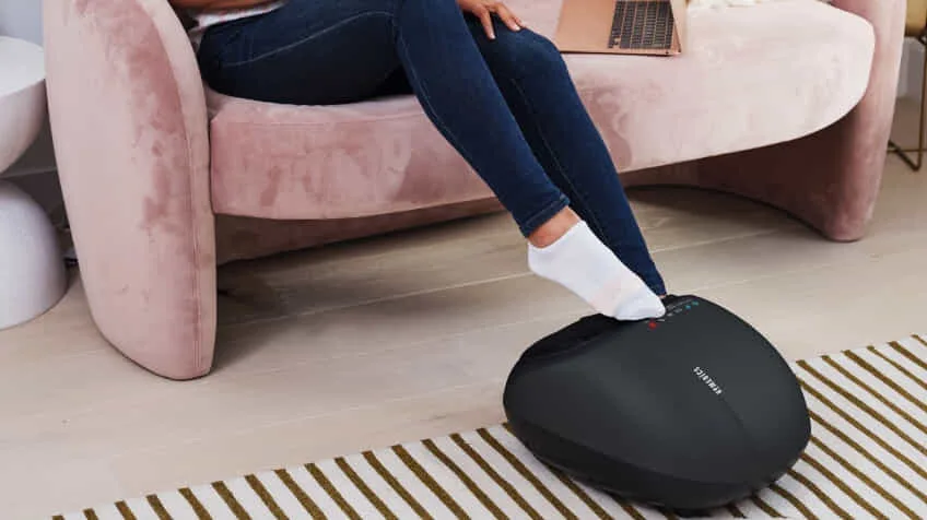 Woman using her Homedics foot massage at home The Good Guys