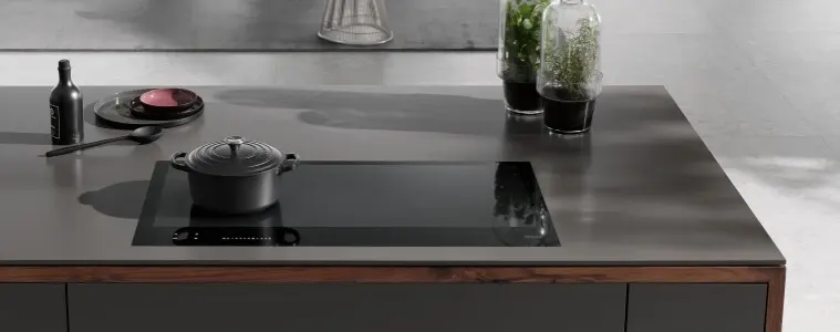 Induction cooktop all black on black counter and black appliances.