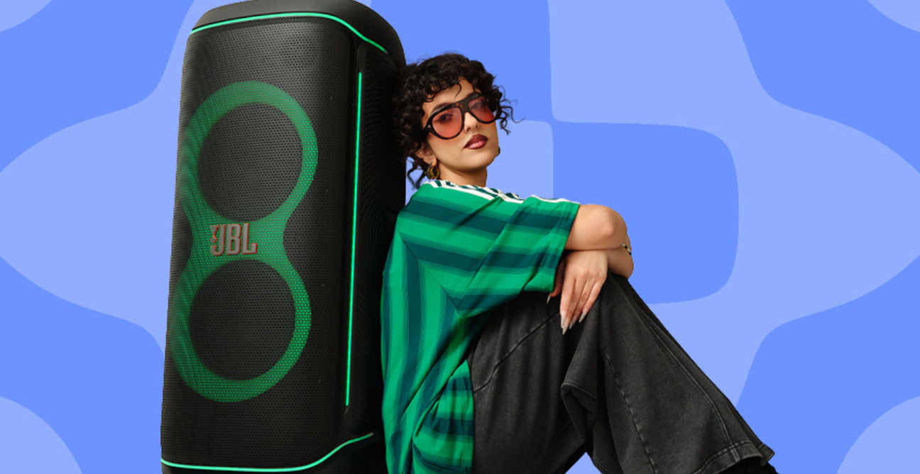 man leans against JBL partybox