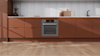 Haier mid-grey oven in a green kitchen