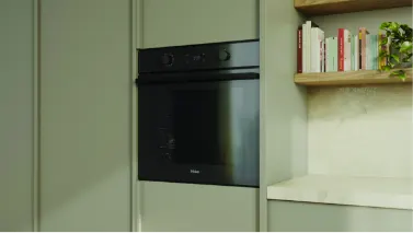Haier mid-grey oven in a green kitchen
