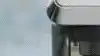 Man pressing button on his De'Longhi Coffee Machine.