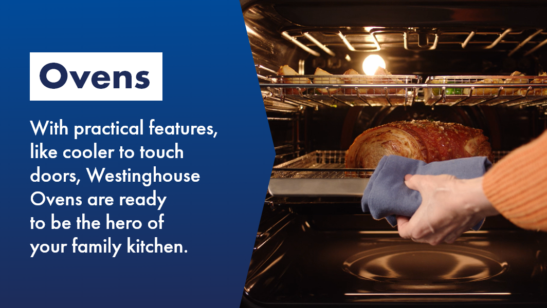 Woman taking perfect roast out of Westinghouse oven, the hero of your family kitchen.