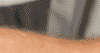 Close up of a man moving a fridge.