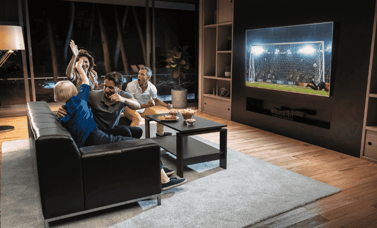 Family enjoying watching the big game on their ultimate home theatre setup