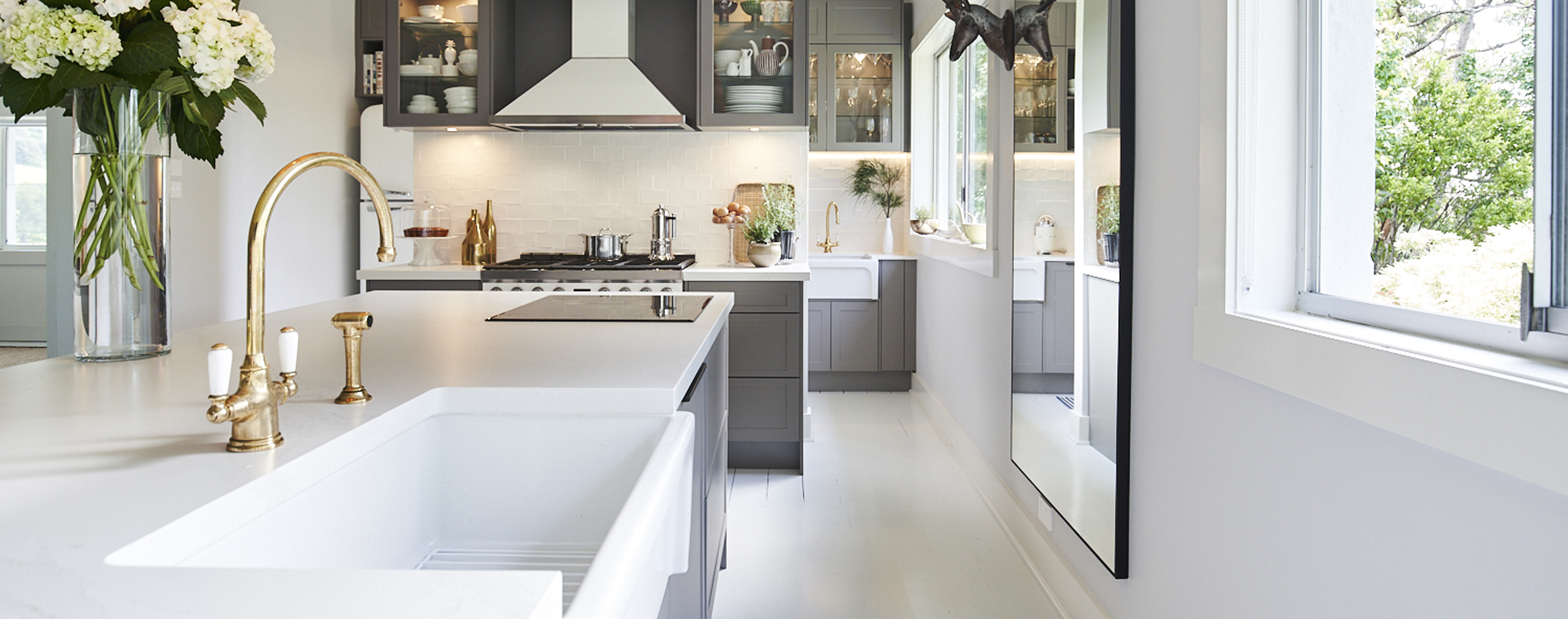 A white stainlesssteel kitchen designed by Kinsman
