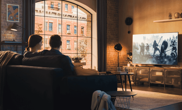 Happy couple relaxing whilst streaming content on their new TV in their loungeroom